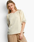 Beach Rose Co. cream knit jacquard top with puff sleeves and pearl embellishments worn by a blonde model