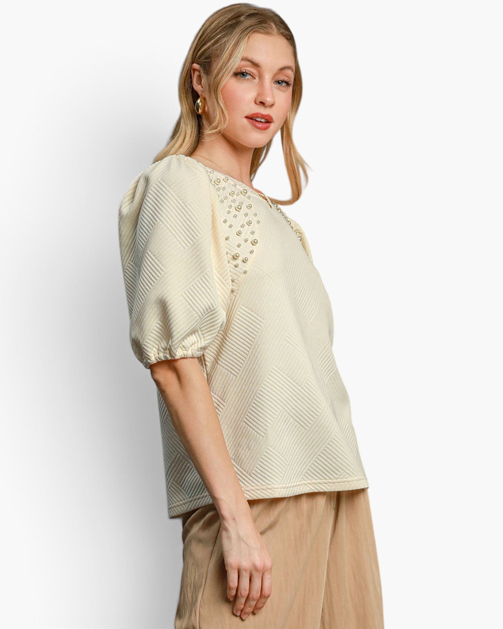 Beach Rose Co. cream knit jacquard top with puff sleeves and pearl embellishments worn by a blonde model