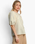 Beach Rose Co. cream knit jacquard top with puff sleeves and pearl embellishments worn by a blonde model