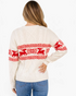 Beach Rose Co. cream cable knit sweater featuring red reindeer and snowflake patterns, shown from the back.