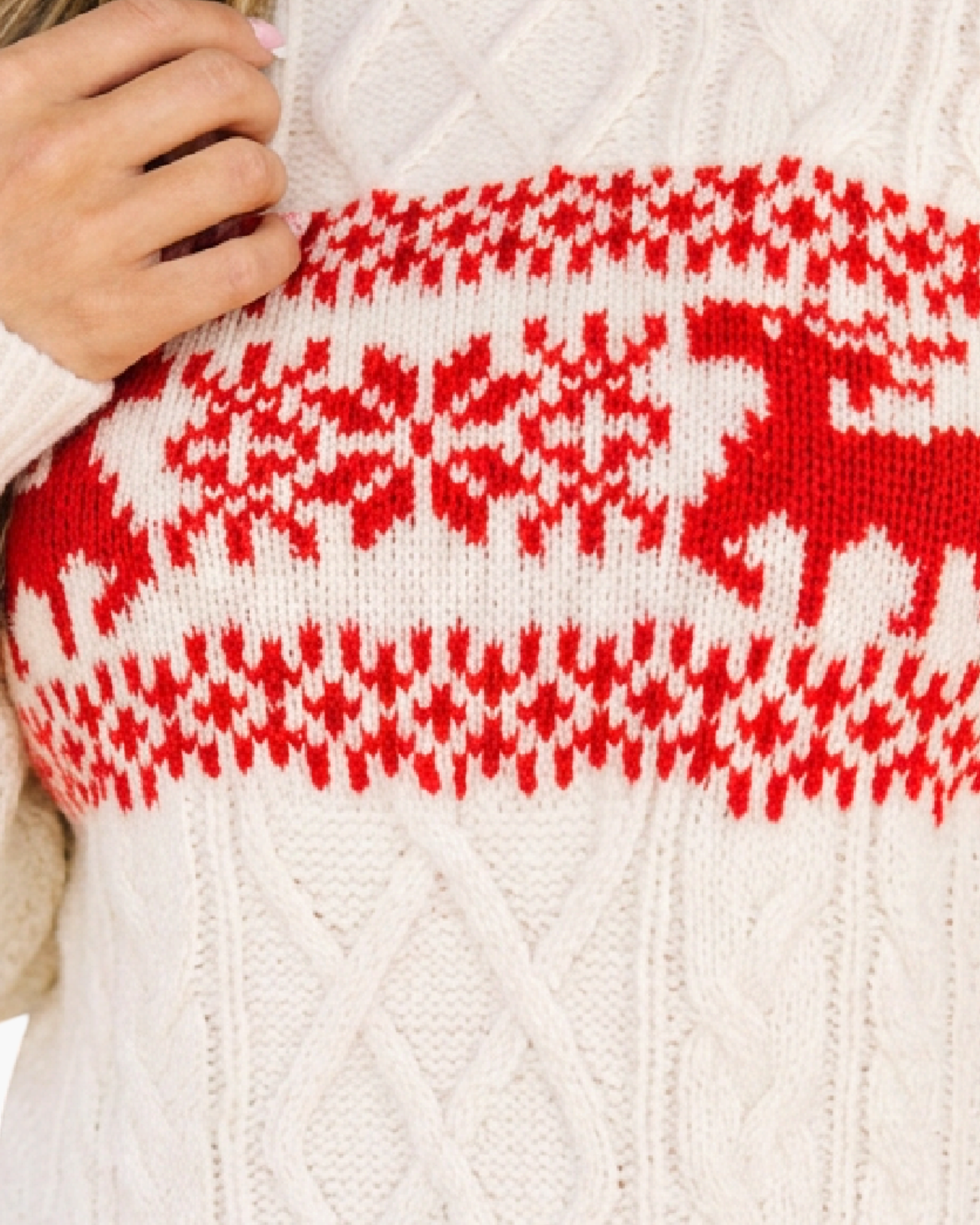 Beach Rose Co. cream cable knit sweater featuring red reindeer and snowflake holiday motifs on the chest
