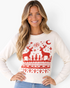 Beach Rose Co. cream crewneck sweater with red reindeer, snowflake, and geometric knit patterns on a smiling model.