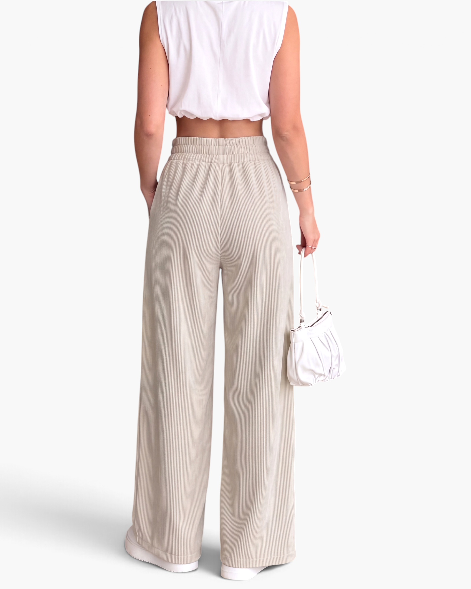 Beach Rose Co. cream ribbed wide-leg pants with an elastic waistband and side pockets, shown from the back.