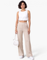 Beach Rose Co. cream ribbed wide-leg pull-on pants with an elastic waistband and side pockets on a model.