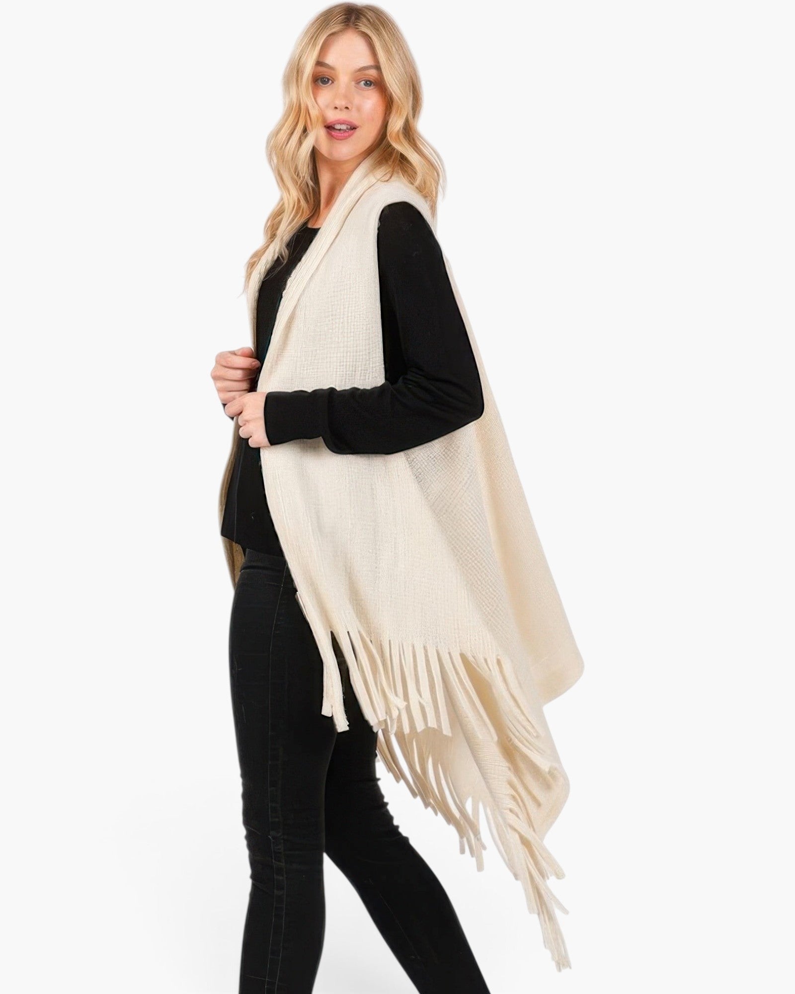 Beach Rose Co. cream knit vest with embossed dotted texture and tassel fringe hem worn by a blonde model.