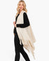 Beach Rose Co. cream knit vest with embossed dotted texture and tassel fringe hem worn by a blonde model.