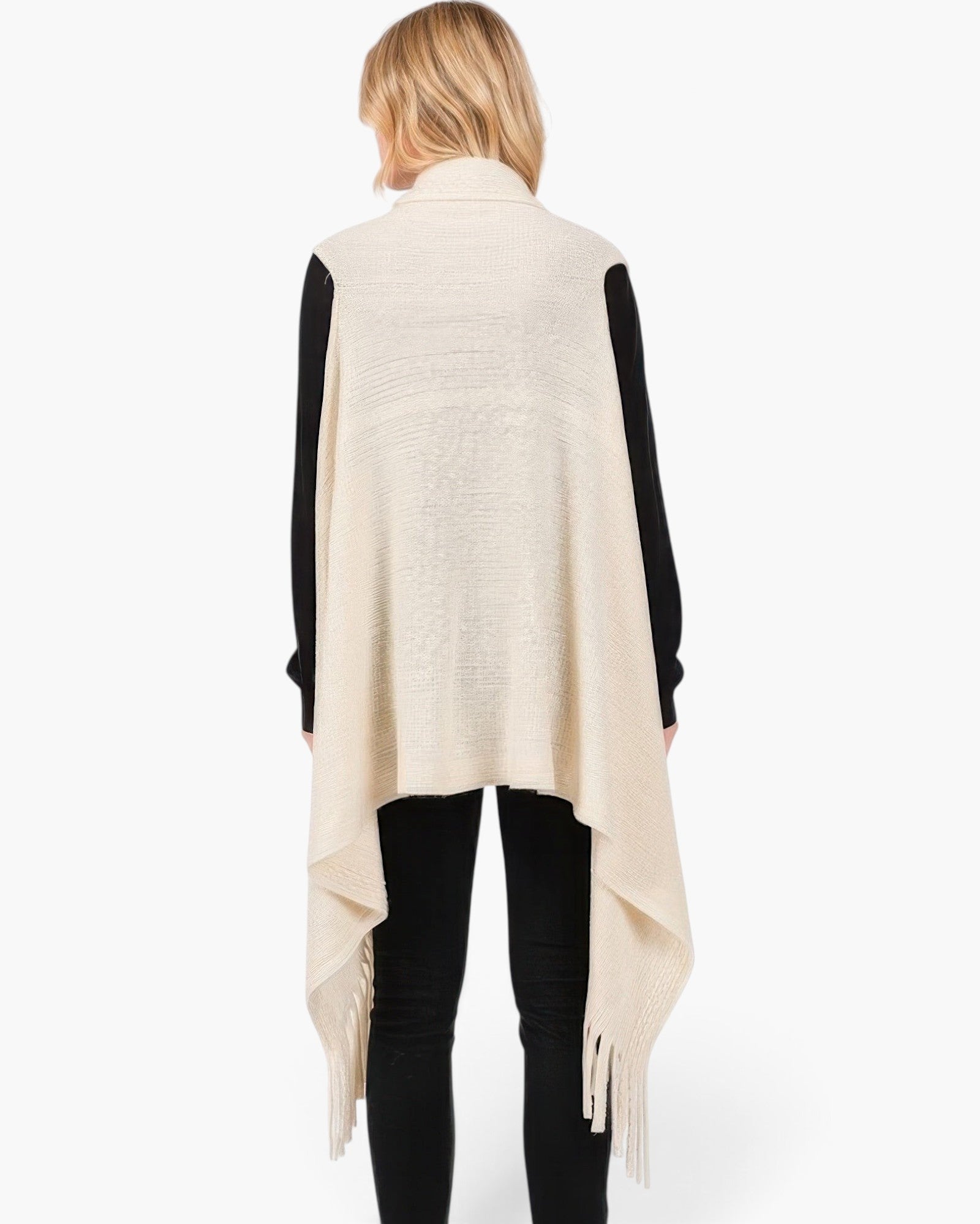 Beach Rose Co. cream knit vest with embossed dotted lines and tassel fringe hem worn over a black long sleeve top.