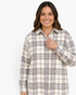 Beach Rose Co. plus-size cream and taupe plaid longline shacket with button front and pointed collar on a smiling model
