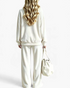 Beach Rose Co. cream velour crewneck top and wide leg pants set worn by a woman from the back view.