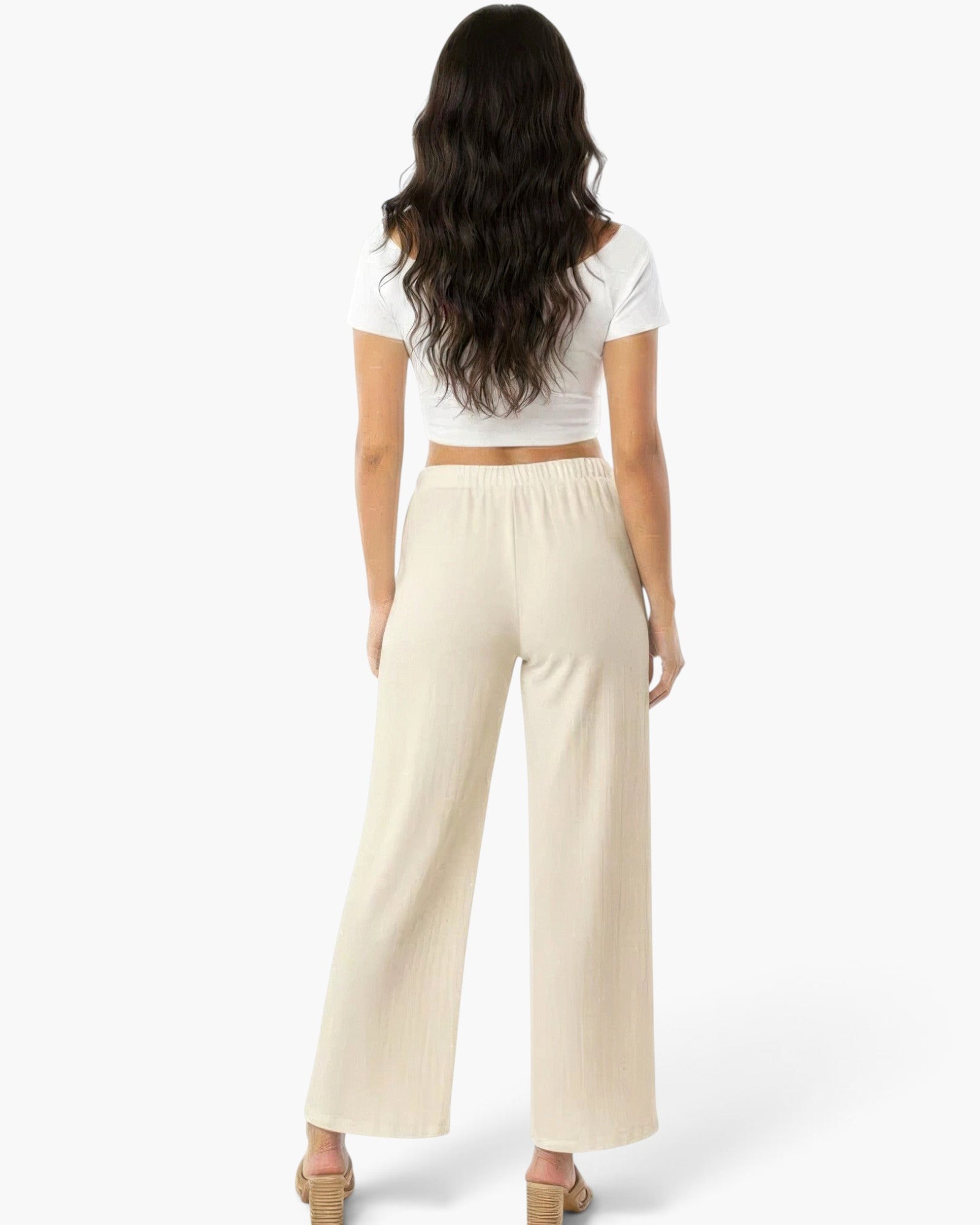 Beach Rose Co. relaxed fit wide-leg cotton pants in cream worn by a woman with long dark hair, back view.