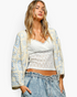 Beach Rose Co. ivory and light blue patchwork crochet open-front cardigan with three-quarter sleeves on a model