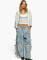 Beach Rose Co. ivory and light blue patchwork crochet open-front cardigan worn by a model with lace tank and jeans