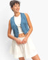 Beach Rose Co. cropped blue denim vest with a V-neck and button-front, worn over a white top and skirt.