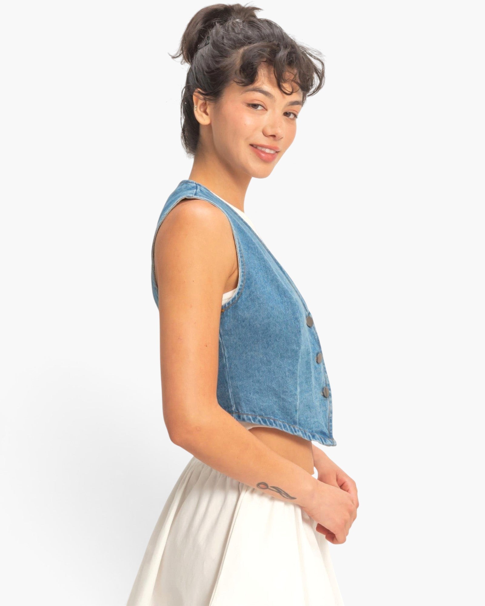Beach Rose Co. cropped blue denim vest with a V-neck and button-front, worn by a model against a white background.