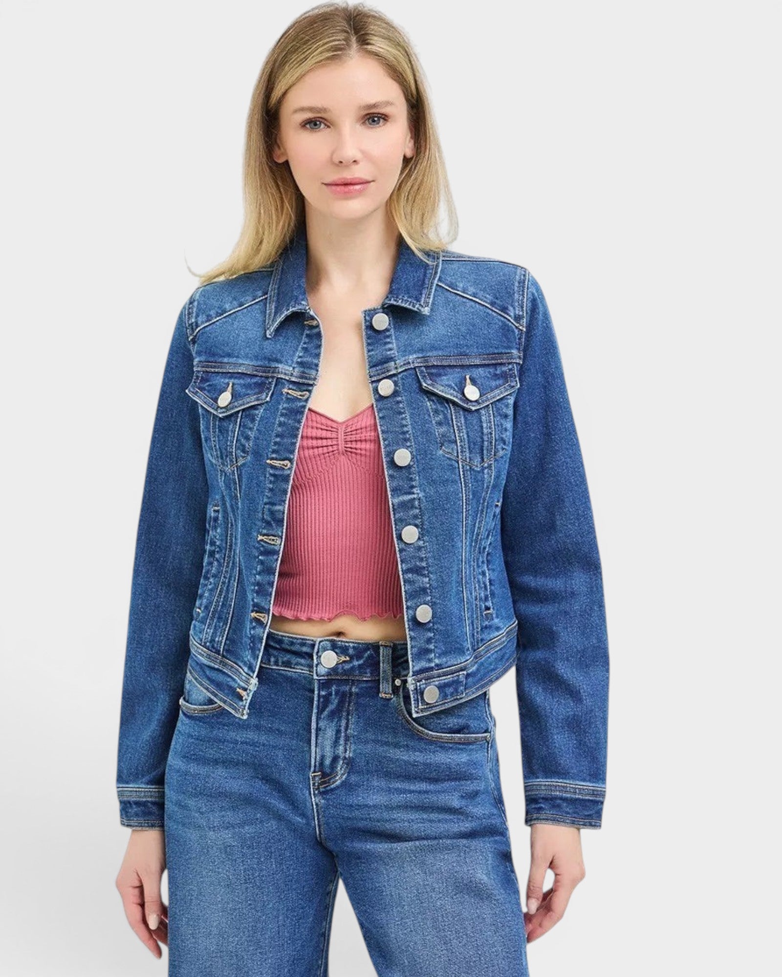 Beach Rose Co. dark wash cropped denim jacket with collared neckline, button front, chest pockets, and button cuffs. Made of cotton blend.