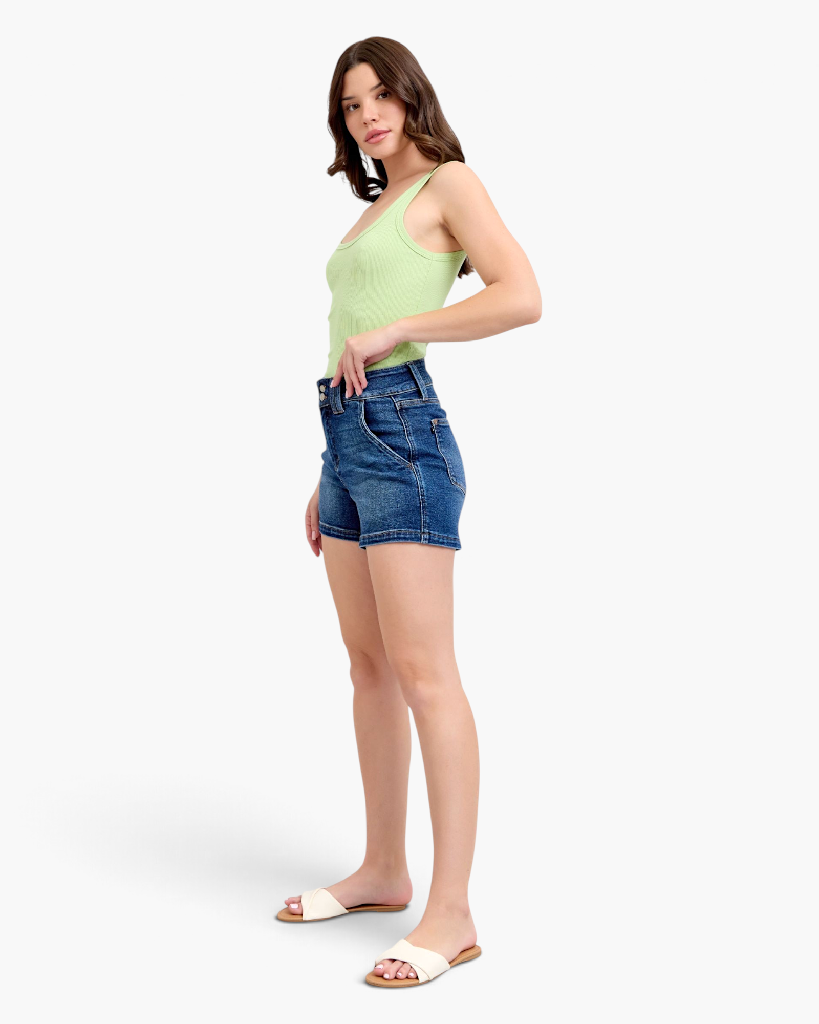 Beach Rose Co. dark wash denim shorts with a wide double-button waistband worn by a model in a light green tank top.