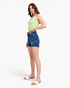 Beach Rose Co. dark wash denim shorts with a wide double-button waistband worn by a model in a light green tank top.