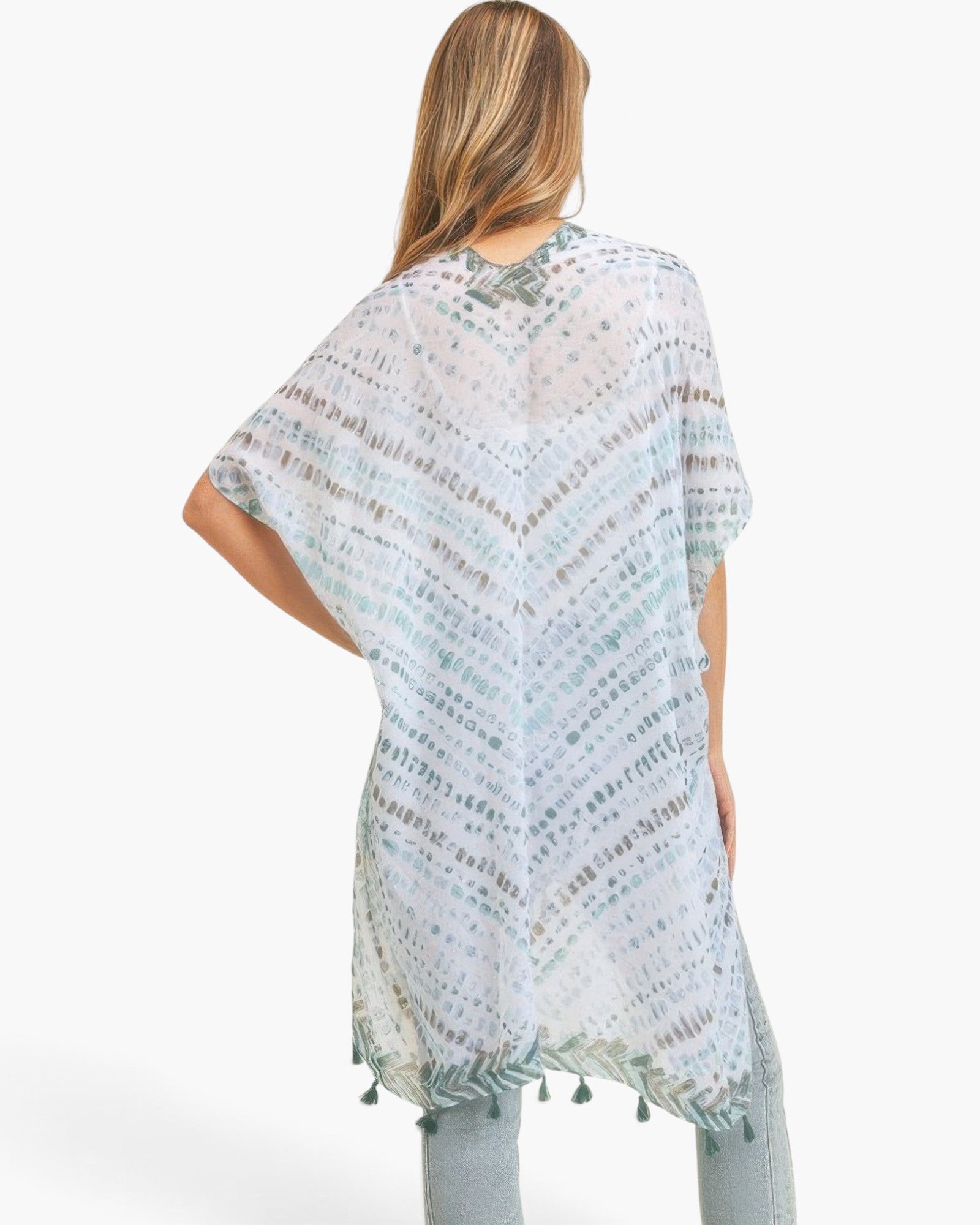 Beach Rose Co. lightweight kimono with a multi-dash pattern and tassel trim, worn over jeans, back view.