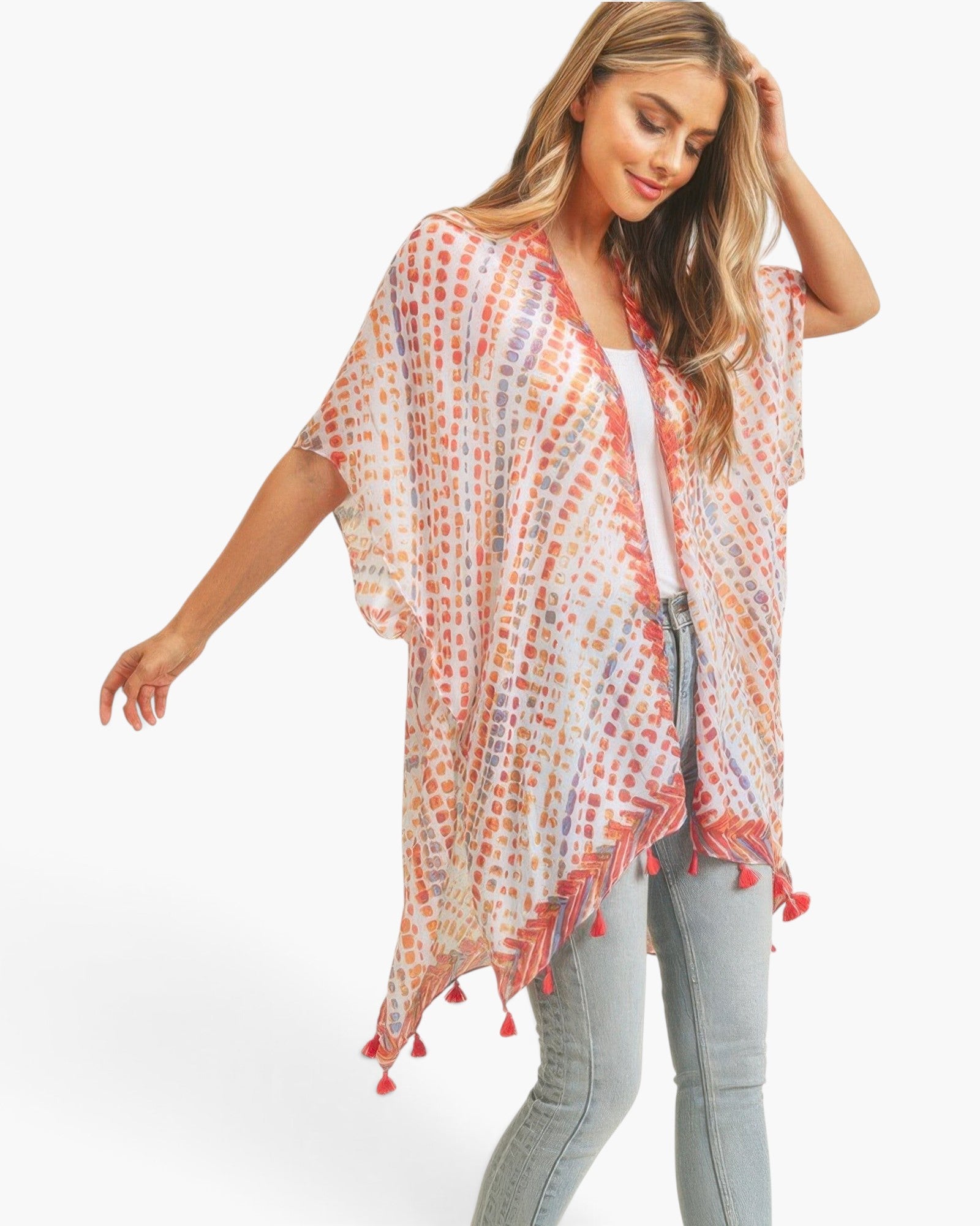 Beach Rose Co. multi dash pattern kimono with tassel trim, worn by a model over a white top and light wash jeans.