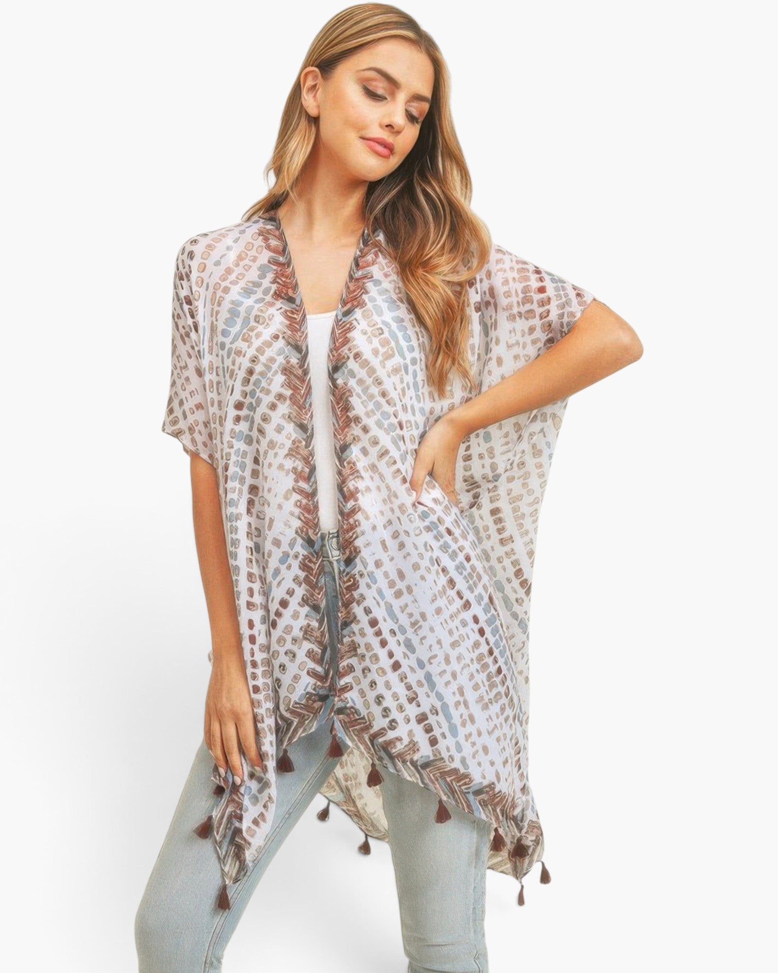 Beach Rose Co. multi dash pattern kimono with tassel trim, worn by a woman over a white top and light wash jeans.