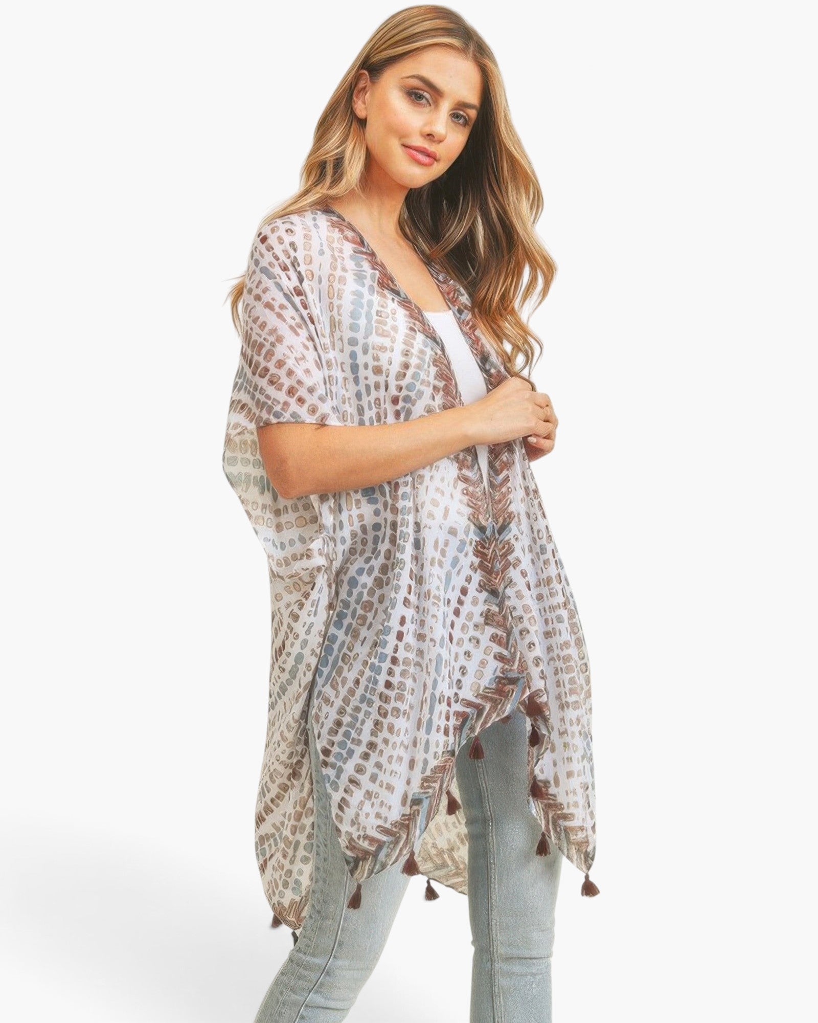 Beach Rose Co. model wearing a lightweight, flowy kimono with a multi-color dash pattern and tassel trim details.