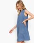 Beach Rose Co. medium wash denim sleeveless A-line dress with side pockets and split neckline on a blonde model