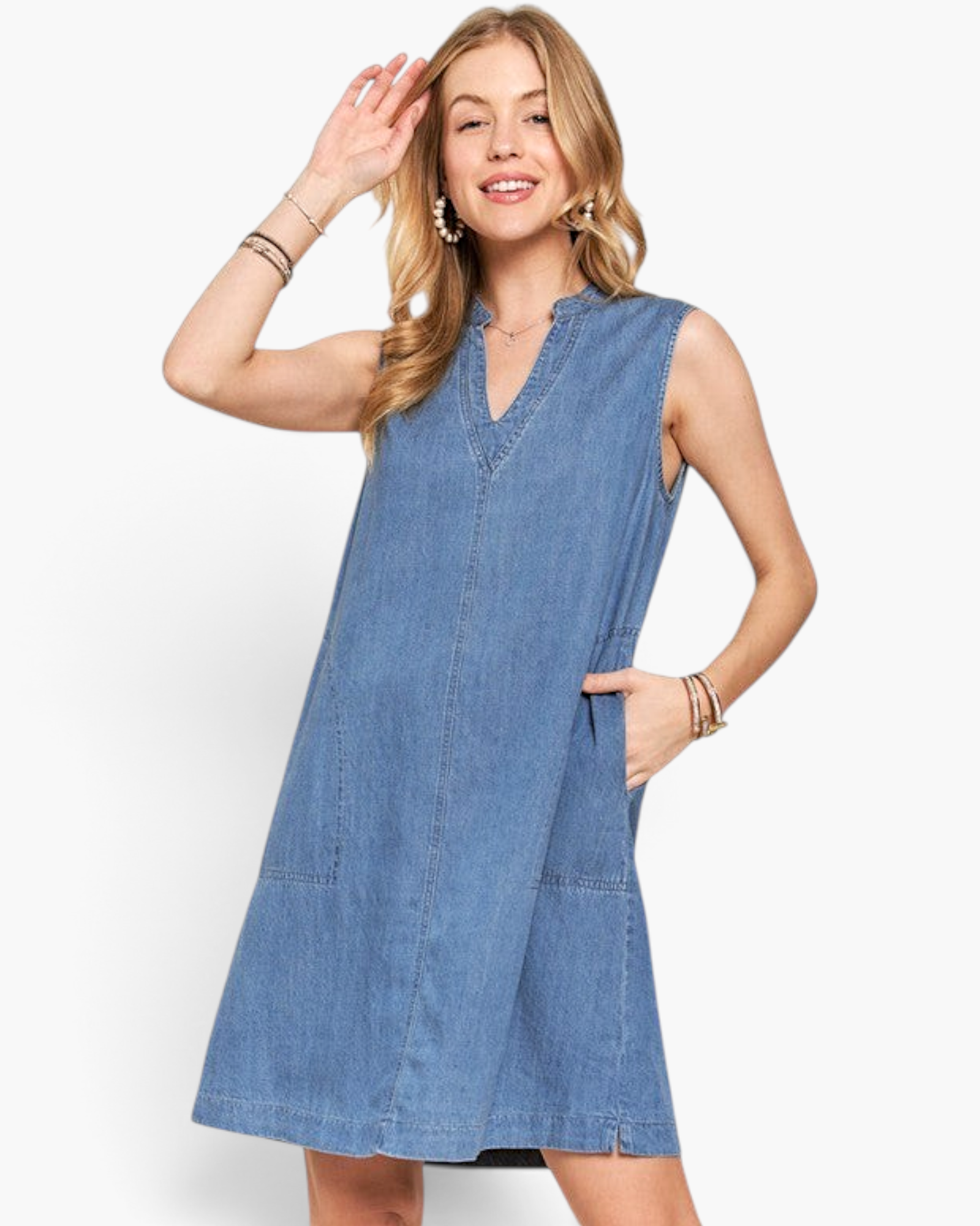 Beach Rose Co. medium wash denim sleeveless A-line dress with split neckline and side pockets on a smiling model