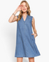 Beach Rose Co. medium wash denim sleeveless A-line dress with split neckline and side pockets on a blonde model