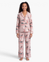 Beach Rose Co. taupe pajama set with festive dinosaur print, featuring button-front top and matching long pants.