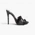 Beach Rose Co. black distressed denim stiletto mules with frayed edges, decorative button, and open toe side view.