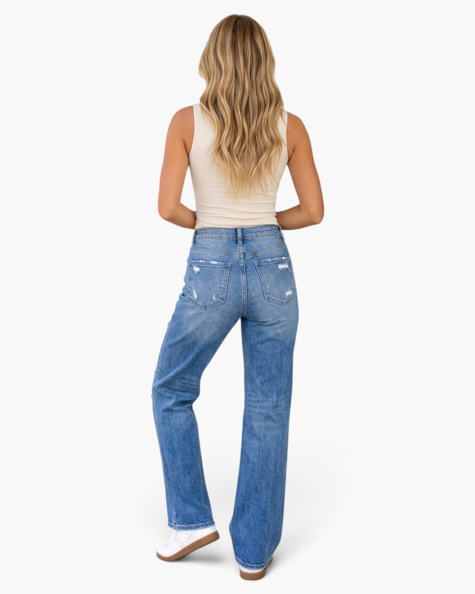 Beach Rose Co. medium wash straight leg jeans with distressed frayed details on a model from the back view