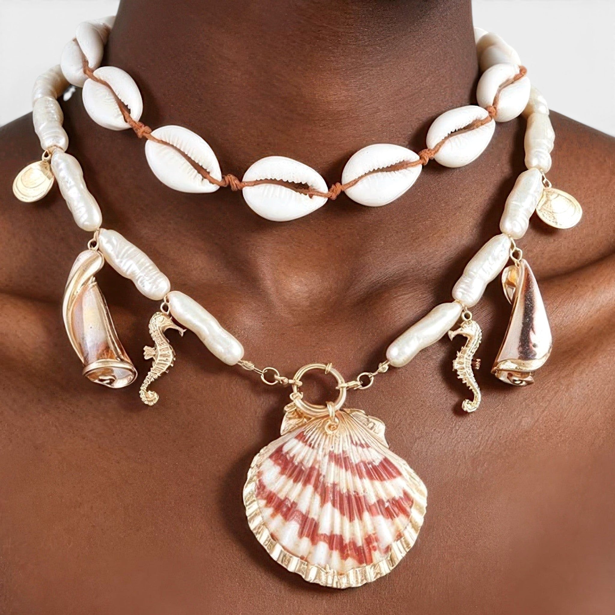 Beach Rose Co. double-layer necklace with cowrie shells, pearl-inspired beads, seahorse charms, and a scallop pendant.