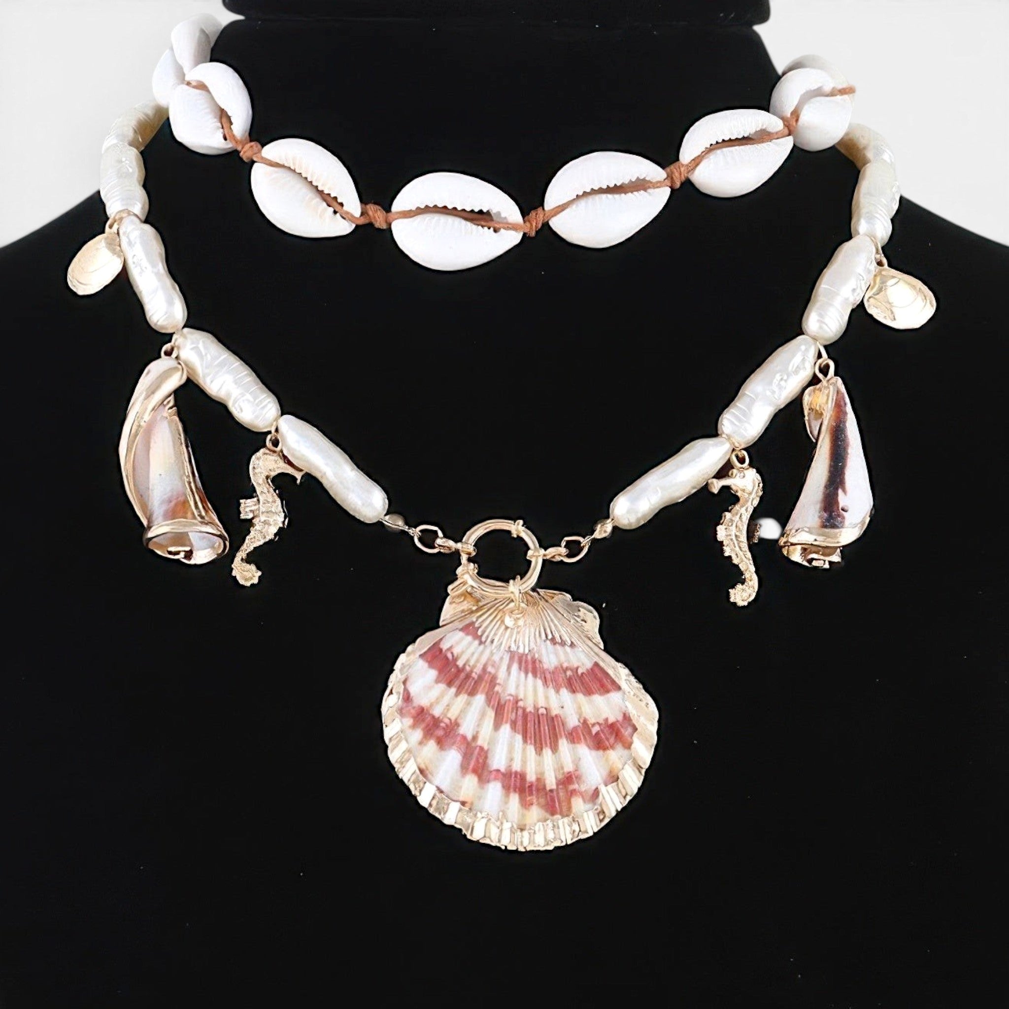 Beach Rose Co. double-layer necklace with cowrie shells, pearl-inspired beads, and nautical seahorse and scallop charms.