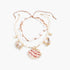 Beach Rose Co. double-layer necklace featuring cowrie shells, pearl-like beads, and gold nautical charms with a scallop shell.