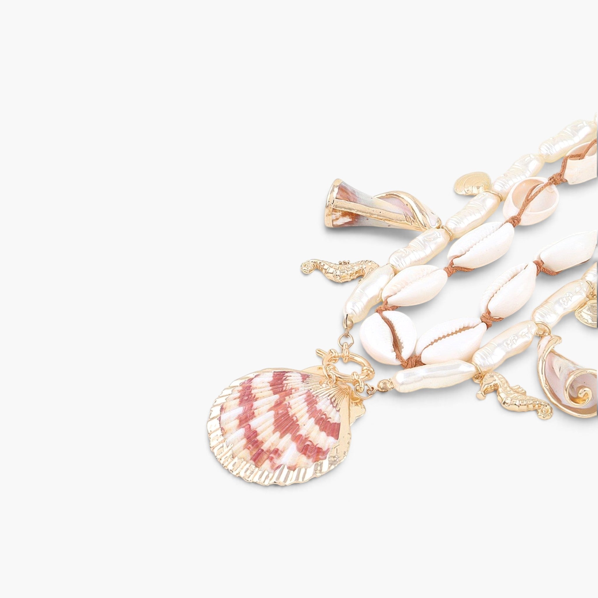 Beach Rose Co. double-layer necklace featuring cowrie shells, pearl-like beads, and gold seahorse and shell charms.