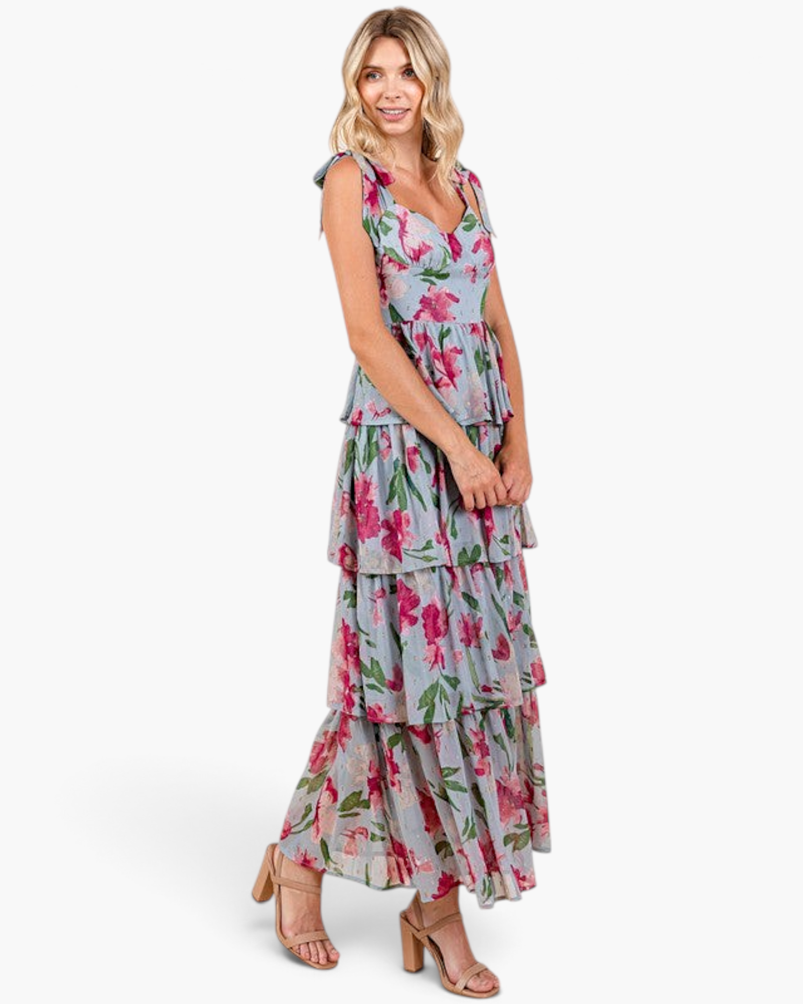 Beach Rose Co. dusty blue maxi dress with pink floral print, ruffled tiers, and shoulder ties on a blonde model.
