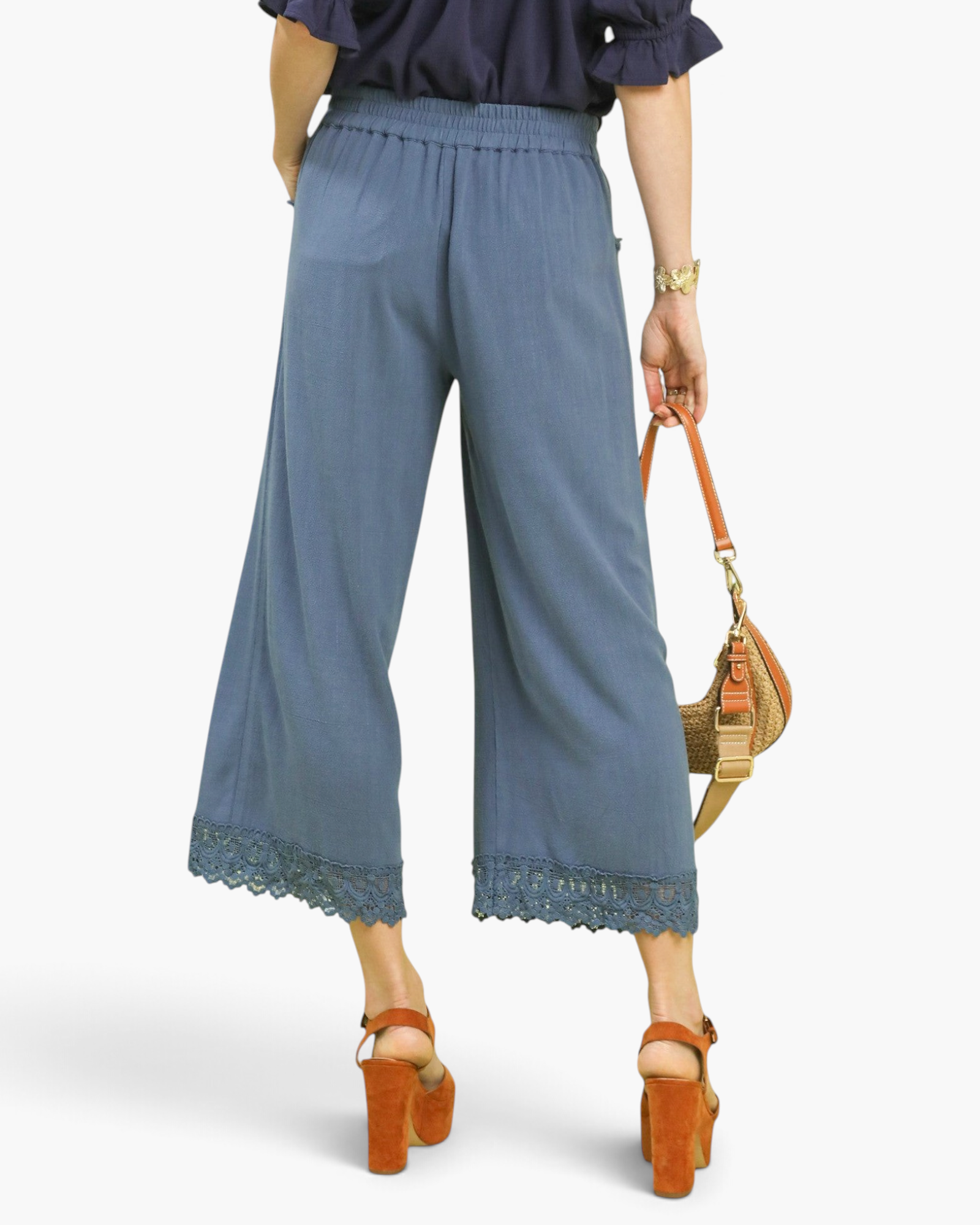 Beach Rose Co. dusty blue wide-leg linen blend cropped pants featuring scalloped lace trim hems, back view.