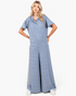 Model wearing a Beach Rose Co. dusty blue button-front wide-leg jumpsuit with patch pockets and short sleeves.