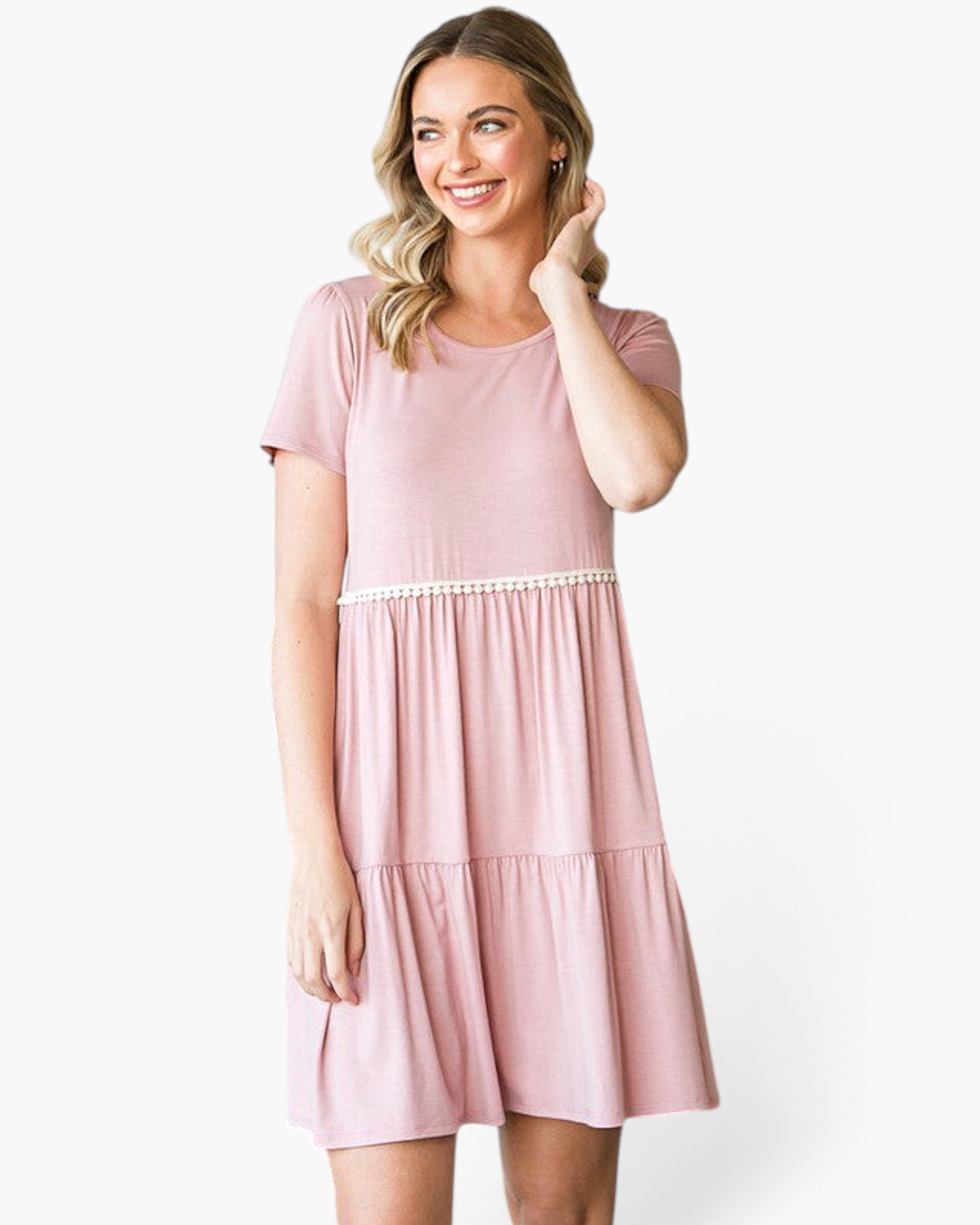 Beach Rose Co. dusty rose babydoll dress with ivory pom-pom trim, tiered skirt, and short sleeves on a smiling model.