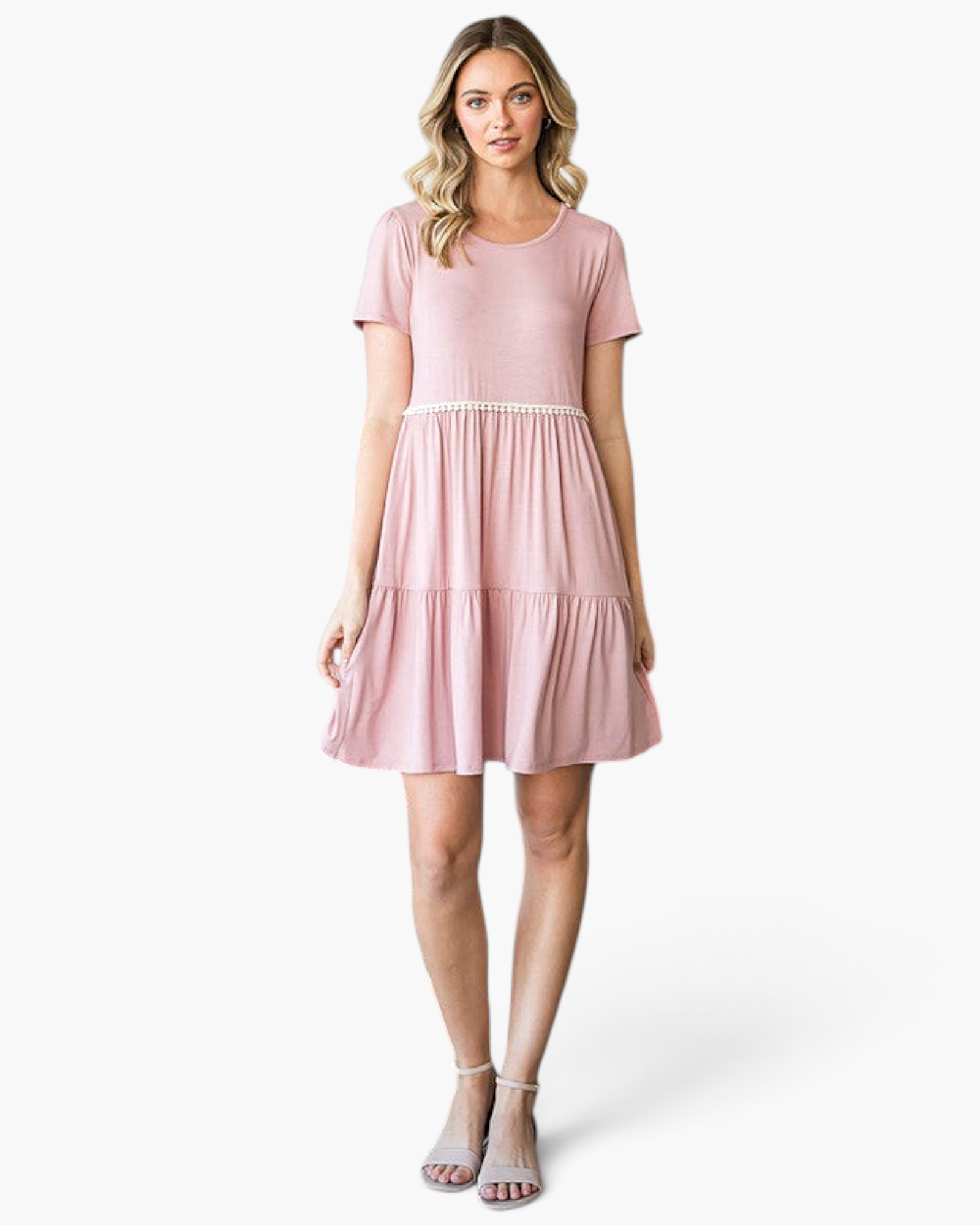 Beach Rose Co. dusty rose babydoll dress with ivory pom-pom trim, tiered skirt, and short sleeves on a model.