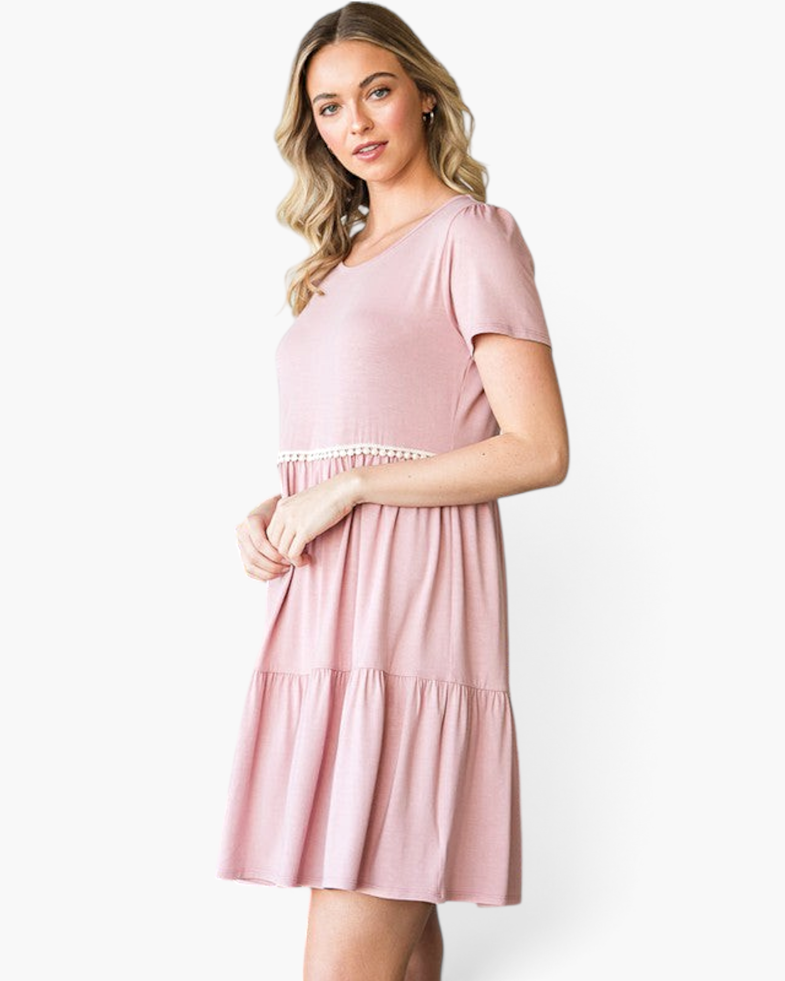 Beach Rose Co. dusty rose babydoll dress with ivory pom-pom trim, tiered skirt, and short sleeves on a blonde model.