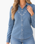 Beach Rose Co. blue denim shirt with white looping embroidery, pointed collar, and snap-front closure on a model.