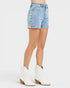 Beach Rose Co. light wash denim shorts with white embroidered floral details, high-rise fit, and short length.
