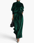 Beach Rose Co. emerald green velvet matching set with a mock neck top and pleated wide leg pants on a model.