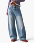 Beach Rose Co. relaxed barrel-leg jeans in faded blue cotton denim with seamed knee details and front scoop pockets.