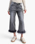 Beach Rose Co. high-waisted washed grey stretch denim pants with a cropped straight-leg fit and bold feather trim hem.