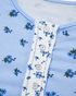 Beach Rose Co. light blue floral print long sleeve top with a buttoned placket and textured contrast trim detail.