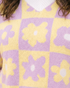 Beach Rose Co. plus size lavender and yellow floral checkerboard sweater with a white ribbed V-neck trim.