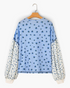 Beach Rose Co. blue floral print long sleeve top with contrasting patterned sleeves and buttoned cuffs.