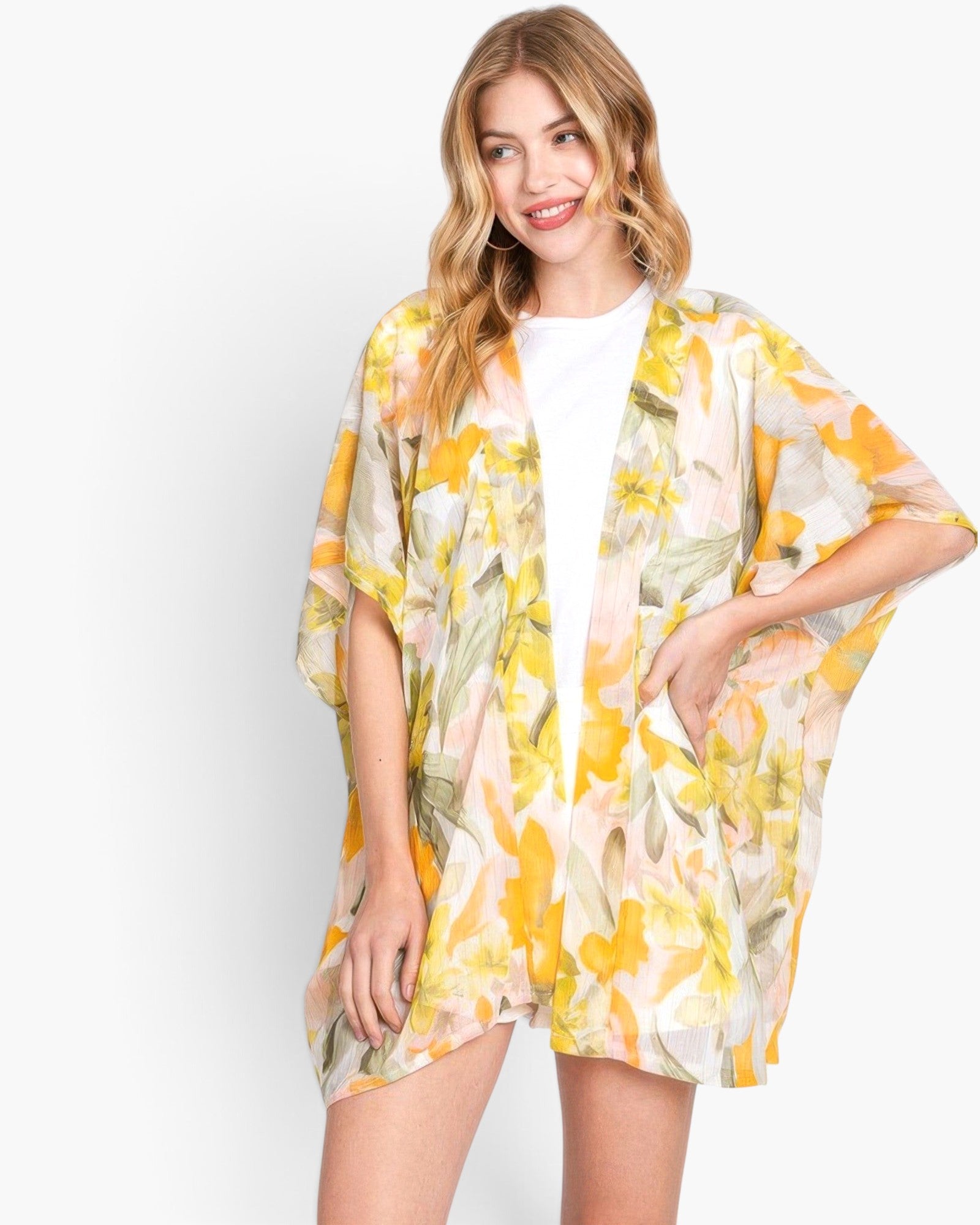 Beach Rose Co. floral print cover-up in yellow and white, worn by a blonde model over a white top.